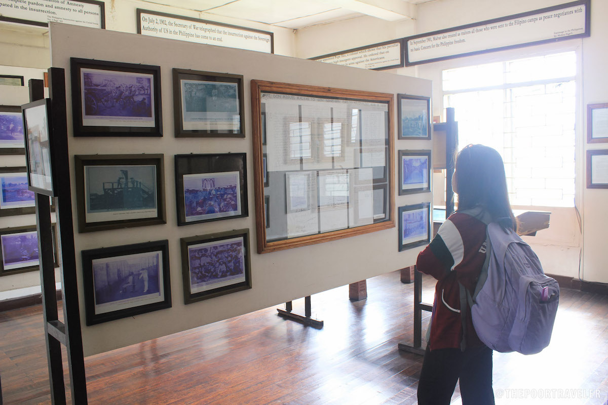 Yoshke's friend Celine enlightening herself with photos of Malvar